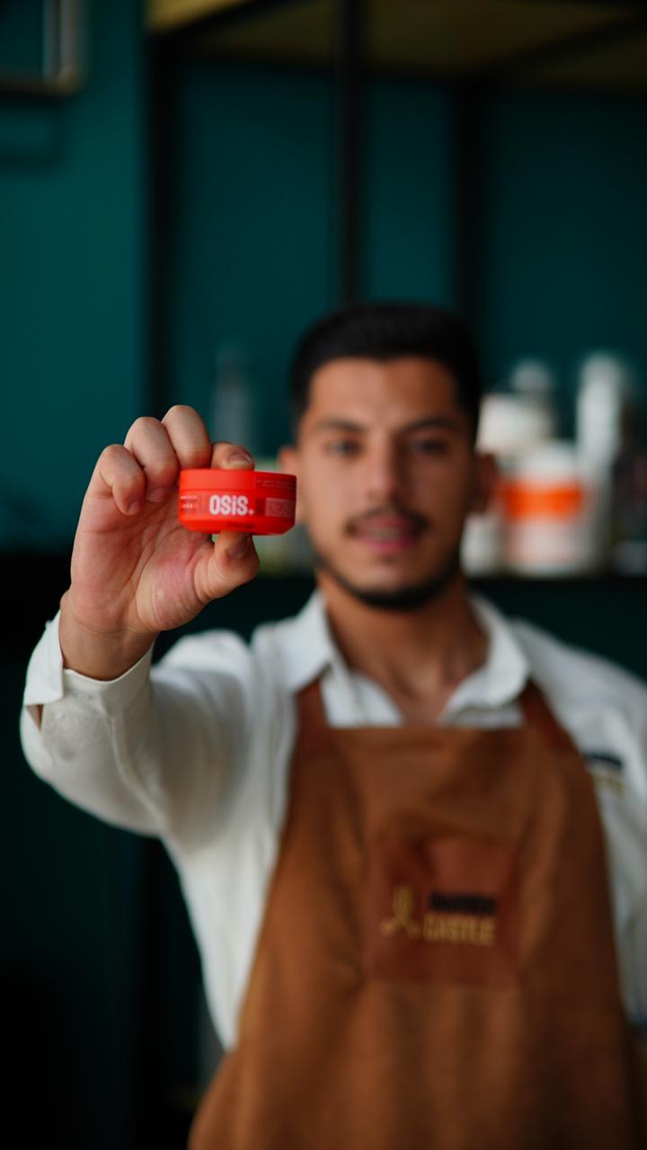 A barber presenting a colour result after a colour service.