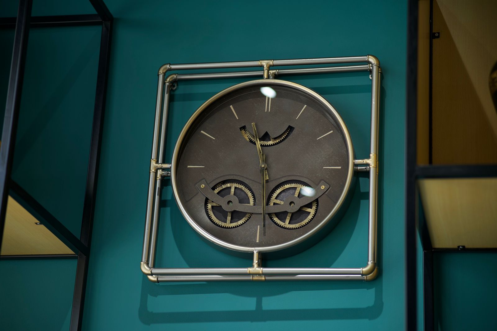 A wall clock framed in brass